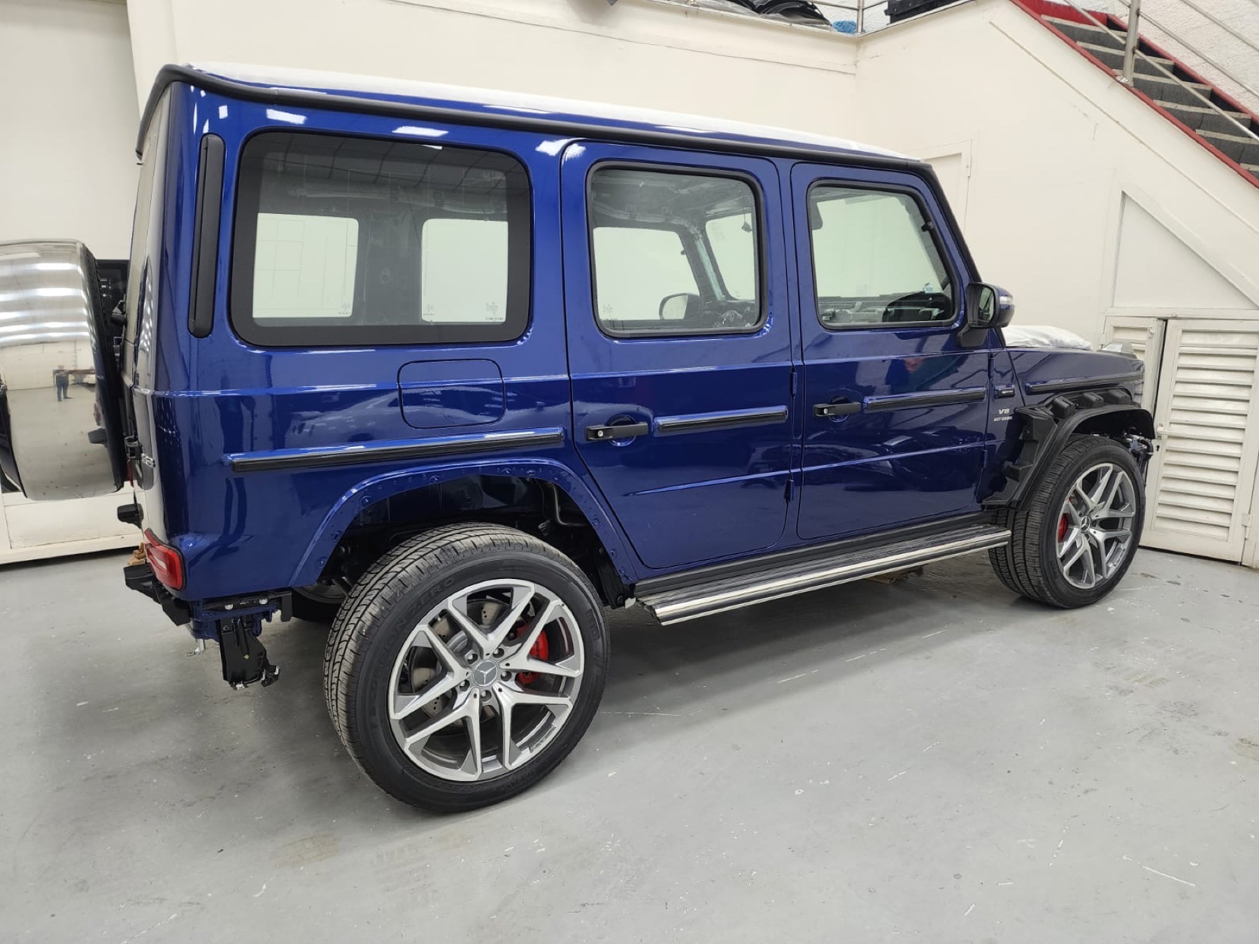 Blue Mercedes-AMG G63 during side body preparation for BRABUS G 800-style conversion in Dubai